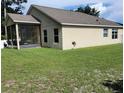 The backyard includes a screened-in porch and a well maintained lawn at 3020 Norlina St, Deltona, FL 32738