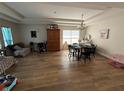 Spacious living room with hardwood floors, tray ceiling, and ample natural light from the large window at 3020 Norlina St, Deltona, FL 32738