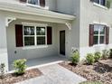 Close up of a charming covered porch with manicured landscaping and attractive brick pavers at 3024 Meleto Blvd, New Smyrna Beach, FL 32168
