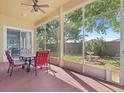 Screened in patio with table and chairs overlooks a well-maintained backyard and mature landscaping at 4918 Oakway Dr, St Cloud, FL 34771