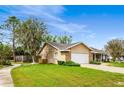 Beautifully landscaped home with a spacious yard, paved driveway, and a brick and vinyl siding exterior at 528 Woodview Dr, Longwood, FL 32779