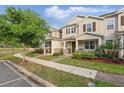 Tan two-story townhome with a sidewalk and blue sky on a sunny day at 5892 Soter Ln, Windermere, FL 34786