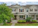 Attractive two-story townhome with covered entry, beautiful landscaping, and shutters at 5892 Soter Ln, Windermere, FL 34786