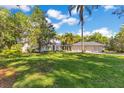 Exterior elevation showcases a spacious lawn, a home, and a three car garage at 6082 Twin Lakes Dr, Oviedo, FL 32765