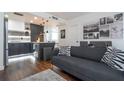 A modern living space featuring stylish furnishings, dark hardwood floors, and an adjacent kitchen area at 6165 Carrier Dr # 3602, Orlando, FL 32819