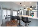 Bright living area with kitchen island, dining table, and comfortable seating next to a large window at 6165 Carrier Dr # 3602, Orlando, FL 32819