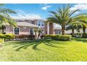 Beautiful home exterior with a well-manicured lawn, mature landscaping, and an inviting architectural style at 6761 Scimitar Ave, Orlando, FL 32812