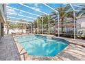 Enjoy this screened-in pool, perfect for relaxing and entertaining with lush landscaping and patio seating at 6761 Scimitar Ave, Orlando, FL 32812