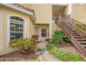 Charming condo entrance features lush landscaping, inviting walkway, and classic architectural details at 692 Seabrook Ct # 103, Altamonte Springs, FL 32714