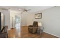 Bright living room featuring hardwood floors, a ceiling fan, and a comfortable recliner near a side table at 80 Lombardy Rd, Winter Springs, FL 32708
