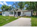 Bright home with new driveway and manicured landscaping at 239 S Lake Cortez Dr, Apopka, FL 32703