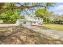 Charming two-story home with a convenient detached garage and a lush green lawn, complete with mature shade trees at 2550 Barren Oak Ct, Deland, FL 32720