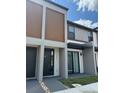 Modern townhome with neutral tones, wooden accents, and stylish front door at 3296 Tranquil Trl, Kissimmee, FL 34747