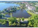 Wide aerial view of a lake with fountain and lush landscaping around residences at 3344 Corona Village Way # B4, Orlando, FL 32835