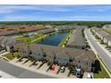 Aerial view featuring pond, playground and convenient parking at 4730 Coral Castle Dr, Kissimmee, FL 34746