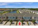 Community aerial shot featuring pond, manicured landscaping and convenient parking at 4730 Coral Castle Dr, Kissimmee, FL 34746