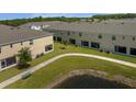 View of the community with green grass, a walking path, and a pond view at 4732 Coral Castle Dr, Kissimmee, FL 34746
