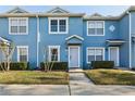Charming two-story townhome featuring a blue exterior, well-maintained landscaping, and inviting front entrance at 534 Wilton Cir, Sanford, FL 32773
