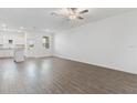 Open-concept living area with wood-look floors leading to a bright, modern kitchen and a back door at 824 Poppy Ln, Dundee, FL 33838
