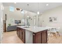 Open-concept kitchen with a large island, stainless steel appliances, and seamless access to the living area at 8896 Reymont St, Orlando, FL 32827