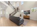 Bright living room featuring high ceilings, a staircase, and contemporary decor at 8896 Reymont St, Orlando, FL 32827