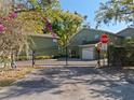 Gated entrance to a green townhome community with beautiful landscaping and secure privacy at 128 Waverly Pl # 128, Orlando, FL 32806