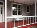 Close up of a charming porch with a swing seat for relaxing at 13018 S Sunset Ter, Winter Garden, FL 34787
