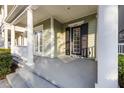Inviting front porch with classic columns and a welcoming entrance at 1457 Resolute St, Celebration, FL 34747