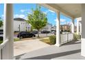 Inviting porch view showcasing the neighborhood's charming street and lush trees at 1457 Resolute St, Celebration, FL 34747