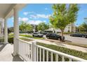 Inviting porch view showcasing the neighborhood's charming street and lush trees at 1457 Resolute St, Celebration, FL 34747