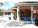 Community poolside patio featuring lounge chairs, dining tables and lush landscaping at 1969 Summer Club Dr # 209, Oviedo, FL 32765