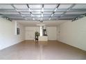 Spacious two-car garage featuring epoxy flooring and ample storage at 22 Laurel Crse, Ocala, FL 34480