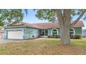 Inviting single-story home with a well-manicured lawn and mature trees providing shade at 2622 Jennifer Dr, Lakeland, FL 33810