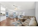 Open-concept living room featuring wood-look floors, a ceiling fan, and sliding glass doors at 2622 Jennifer Dr, Lakeland, FL 33810