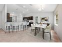 Dining area featuring modern lighting, bar seating, and a stylish table with chairs at 304 Woods Landing Dr, Lady Lake, FL 32159