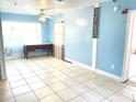 Spacious living room with tile floors, ceiling fan, and bright natural light at 307 S Hiawassee Rd, Orlando, FL 32835