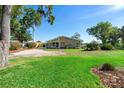 The house features a well-maintained lawn and inviting curb appeal with mature trees around the property at 3655 E Osceola Rd, Geneva, FL 32732
