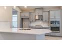 Modern kitchen boasts stainless steel appliances, ample counter space, and stylish gray cabinetry at 4147 Coral Harbour Rd, Kissimmee, FL 34758
