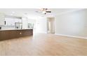 Bright and airy living room with modern flooring, recessed lighting, and open layout into the kitchen at 54 Malauka Trak, Ocklawaha, FL 32179