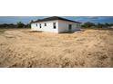 New construction home features a modern exterior, white siding, dark roof, and minimalist design at 55 Laurel Crse, Ocala, FL 34480