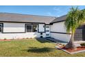 Beautiful home with manicured lawn, freshly painted exterior with black accents and a stylish front door at 8143 Britt Dr, Orlando, FL 32822