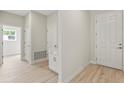 Bright entryway featuring wood-look floors and a built-in cabinet and countertop, creating a welcoming and functional space at 1755 Waterview Dr, Leesburg, FL 34748