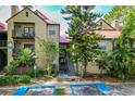 Exterior view of a multi-story condo building with red roof, stairs, landscaping and accessible parking at 200 Afton Sq # 108, Altamonte Springs, FL 32714