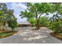 Charming home with a manicured front yard, picket fence, and long driveway at 1010 N Clayton St, Mount Dora, FL 32757