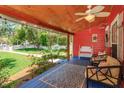 Relaxing front porch with cozy seating, ceiling fan and wood flooring for outdoor comfort and curb appeal at 1010 N Clayton St, Mount Dora, FL 32757