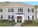 Charming two-story building with painted brick, black shutters, and well-maintained landscaping at 302 Lewfield Cir # 302, Winter Park, FL 32792