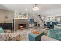 Inviting living room featuring a decorative fireplace, open floor plan, and stairs at 1013 Love Ln # 32, Apopka, FL 32703