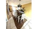 Welcoming dining area adjacent to the living room with stylish lighting and a cozy area rug at 1098 Henry Balch Dr, Orlando, FL 32810