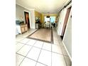 Open dining room featuring light colored flooring, decorative rug, and views into the living area at 1098 Henry Balch Dr, Orlando, FL 32810