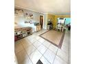Bright living room with tile flooring and neutral walls leads to a dining area, perfect for entertaining at 1098 Henry Balch Dr, Orlando, FL 32810